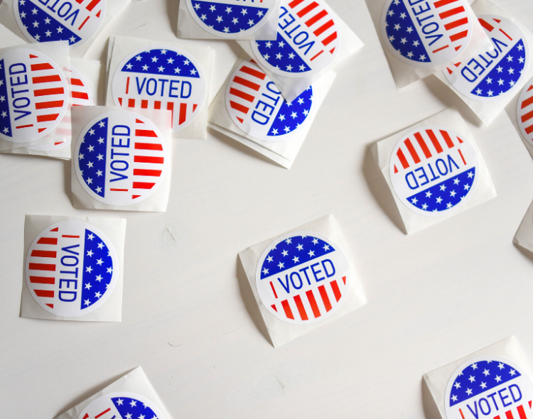 Several "I Voted" stickers on a white surface