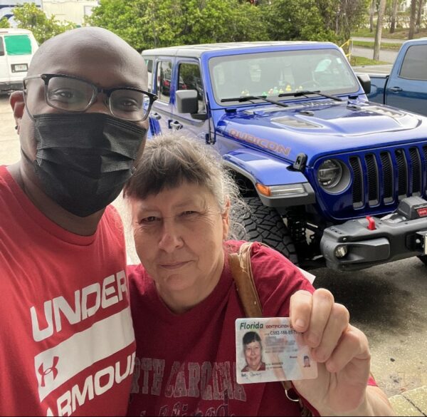 Od’Juan Whitfield of Faith in Public Life takes a selfie with Dolly Canning and her new Florida ID card.