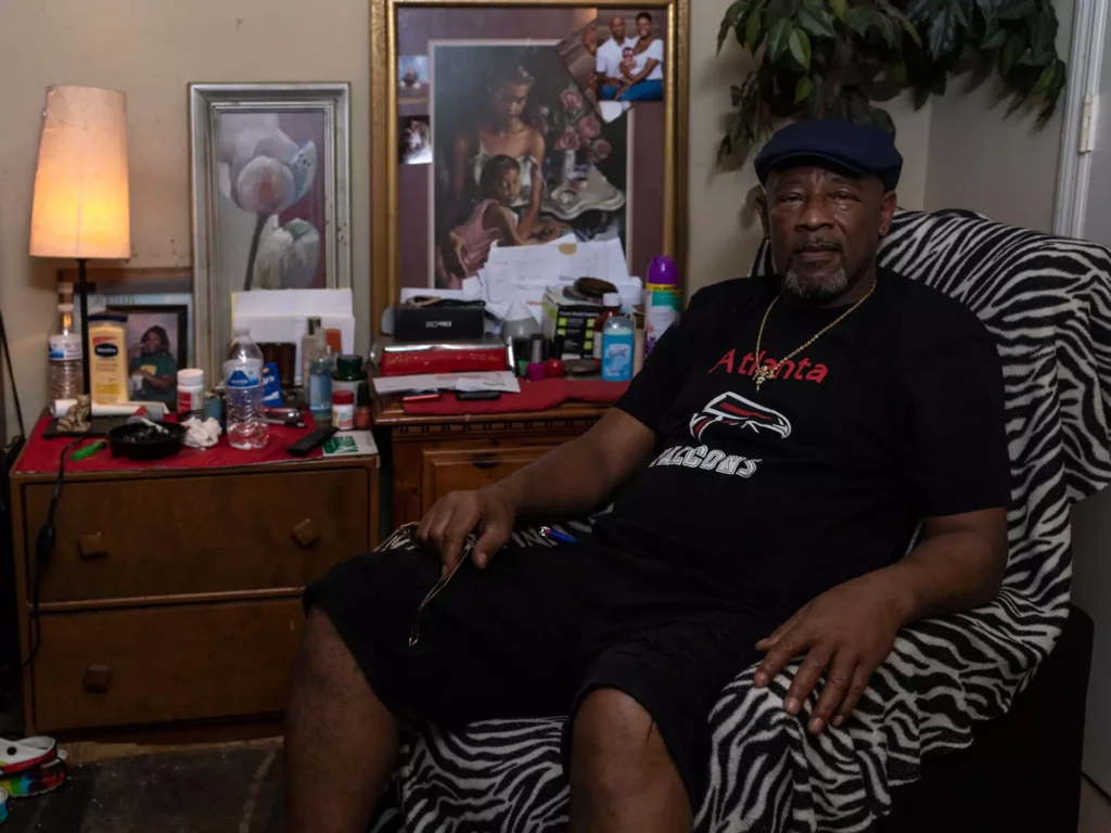 Keith Bowens poses for a portrait in his home in Lithonia, Ga. on Nov. 6. 