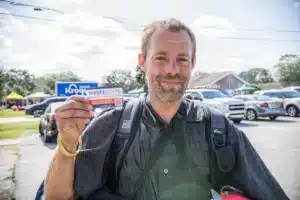 A voter with a VoteRiders voter ID information card 