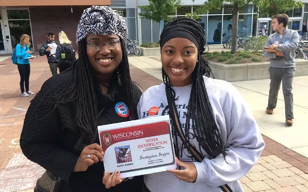 college voters in Madison holding a voter identification card