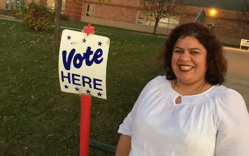 woman standing next to a sign that says 