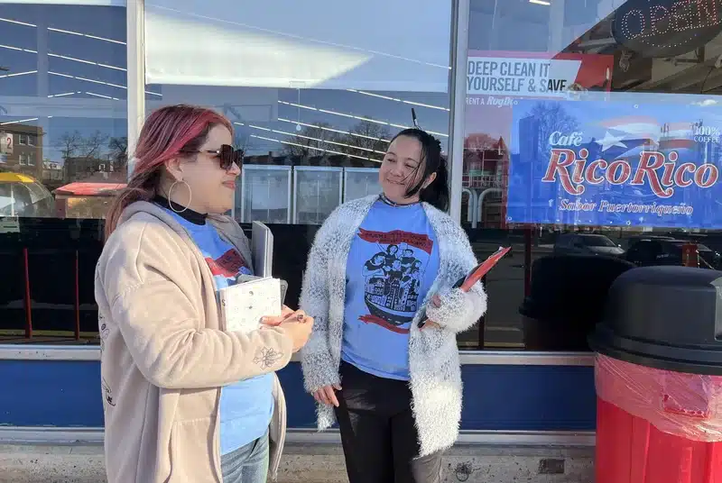 
Katherine De Peña, left, a field organizer in charge of Make The Road Pennsylvania's voter registration program, and her colleague Mayra Del Toro wait to greet eligible voters in Spanish outside a CTown supermarket in Reading, Pa.
Hansi Lo Wang/NPR